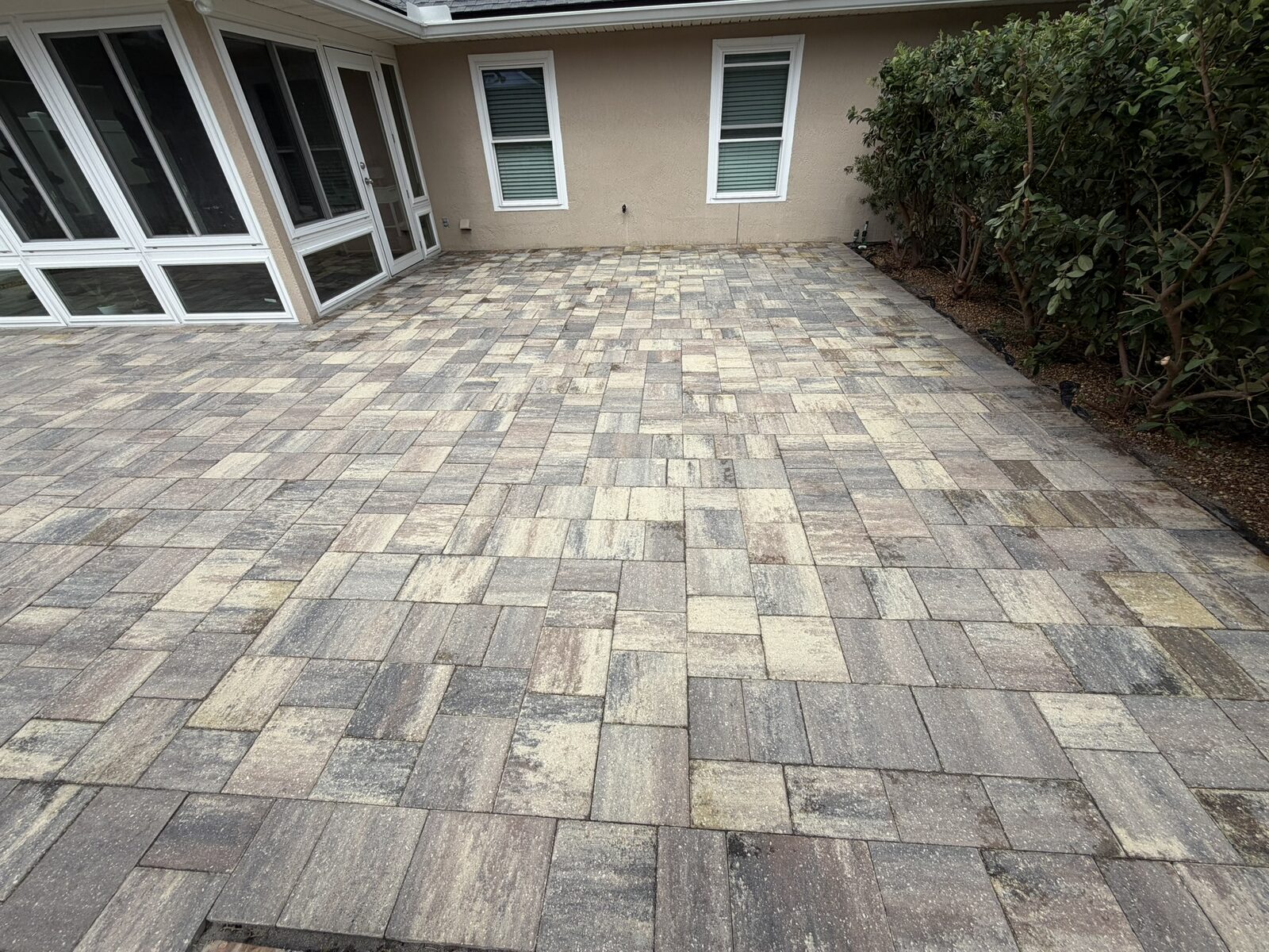 Before: Faded paver patio before surface work