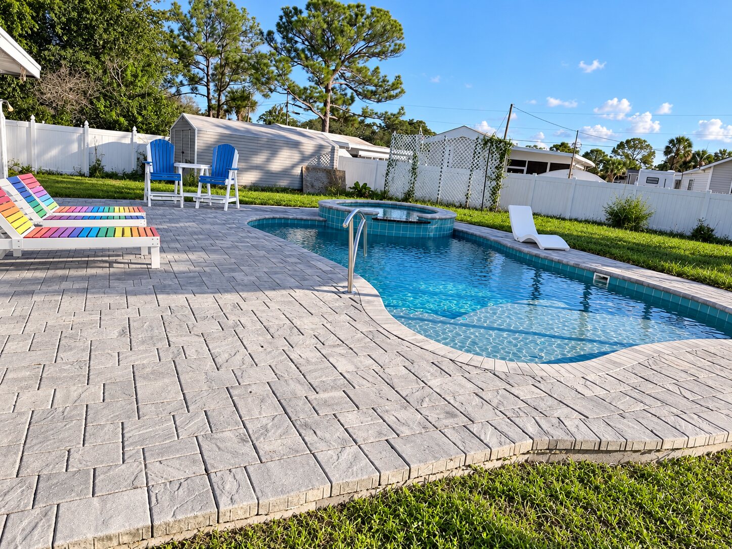Gray interlocking pavers around a residential swimming pool